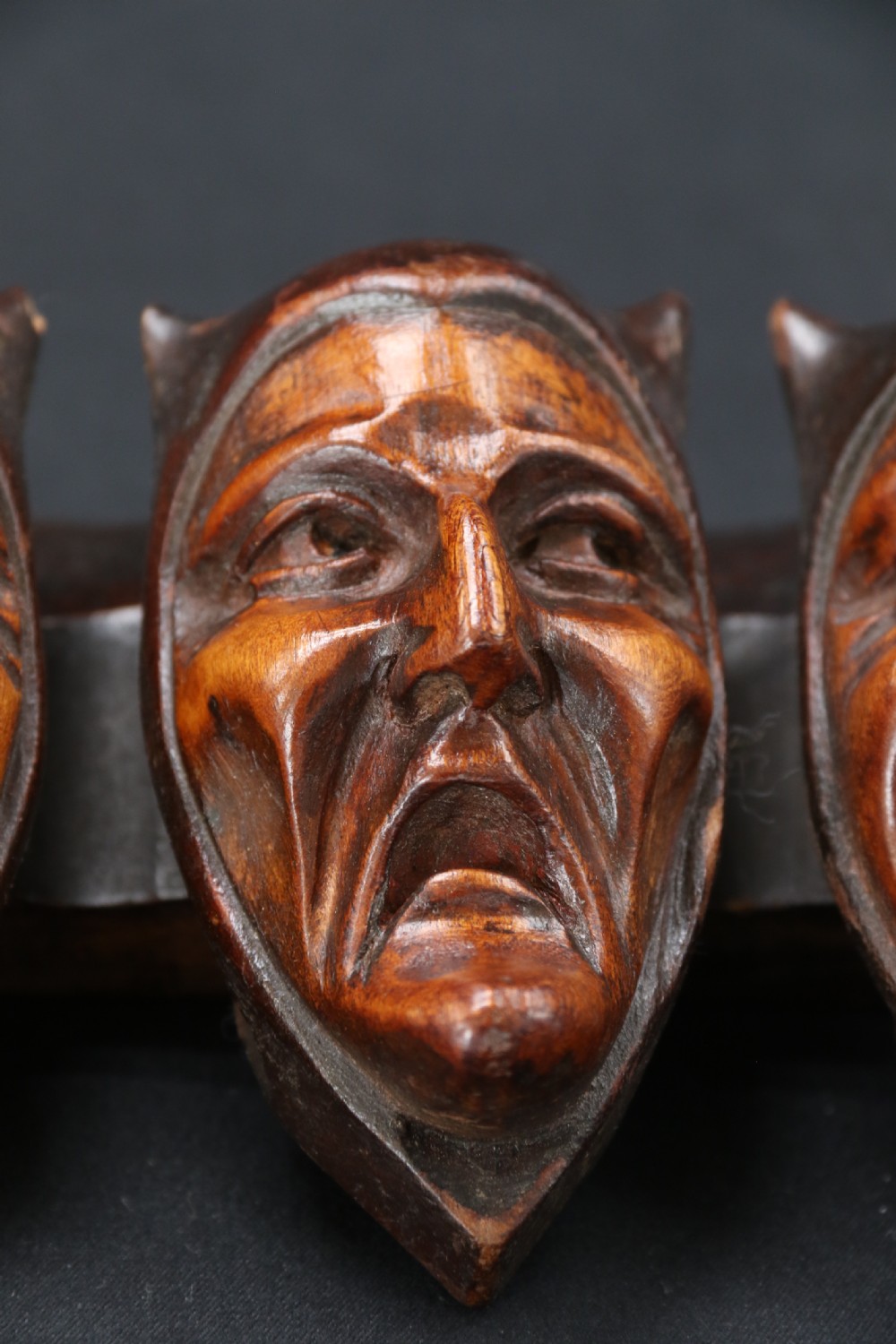 A superb Black Forest spoon rack carved in the devilish faces of the seven deadly sins. View IX