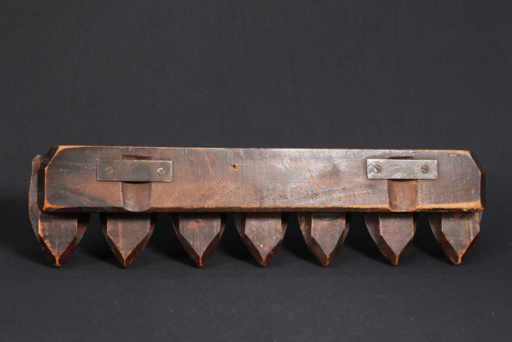 A superb Black Forest spoon rack carved in the devilish faces of the seven deadly sins. View XIII