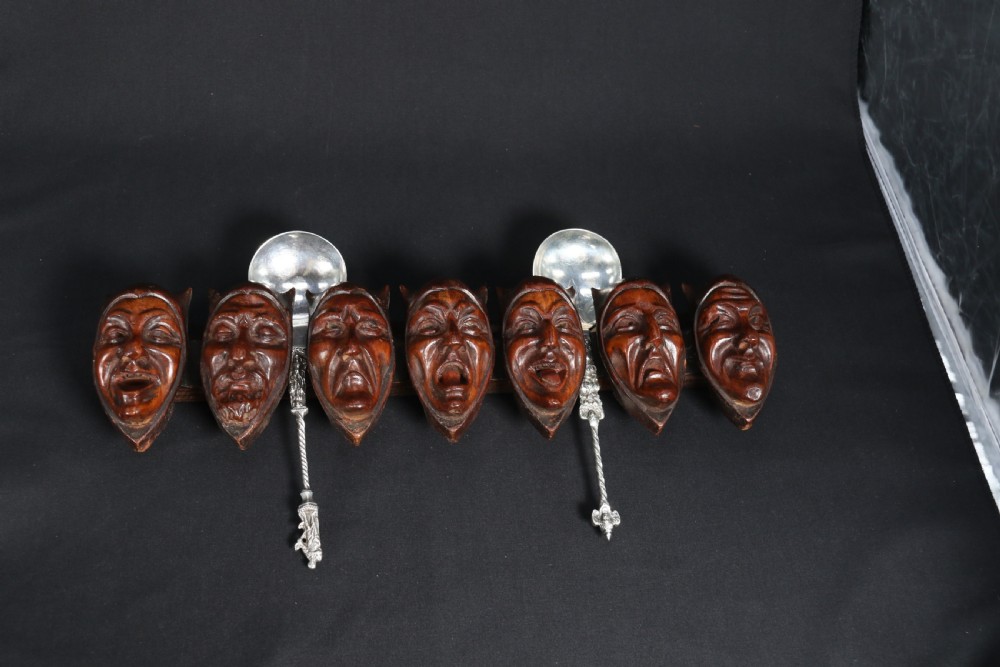 A superb Black Forest spoon rack carved in the devilish faces of the seven deadly sins. View XIV