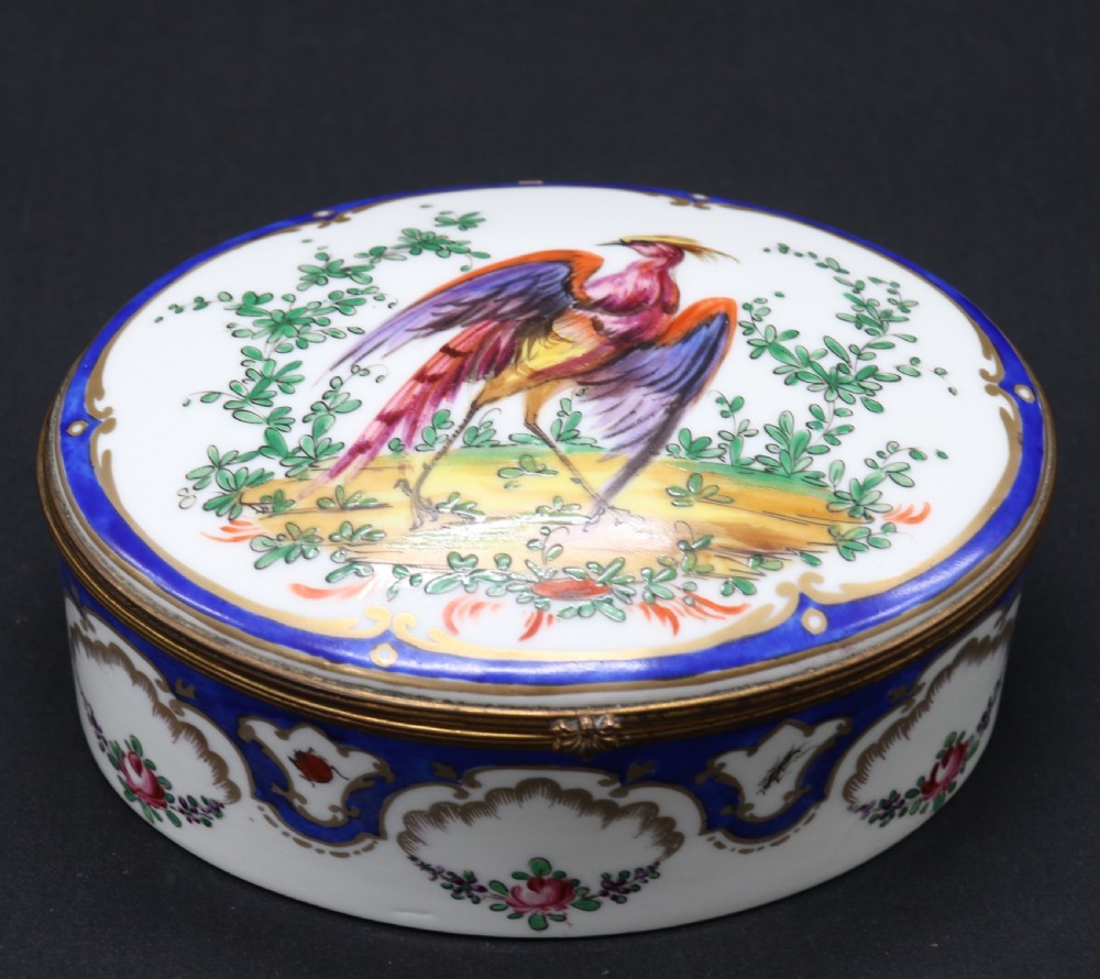 A late 19th century French hand painted porcelain oval box by Samson of Paris
