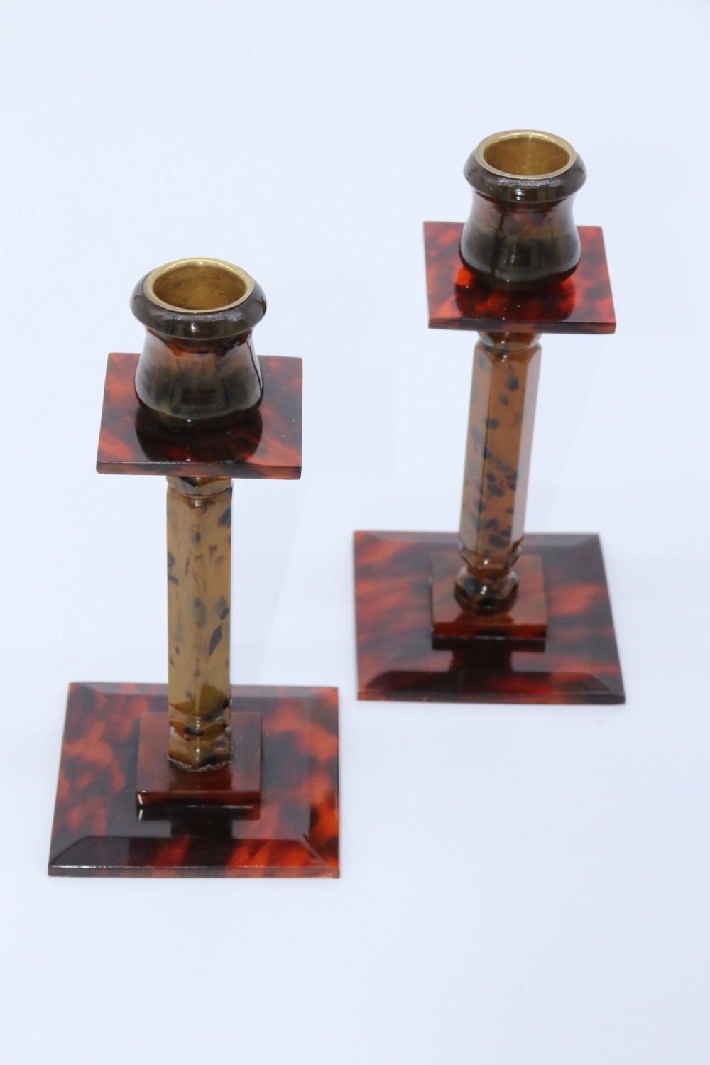 A pair of Art Deco tortoiseshell and clouded butterscotch Bakelite candlesticks View XII