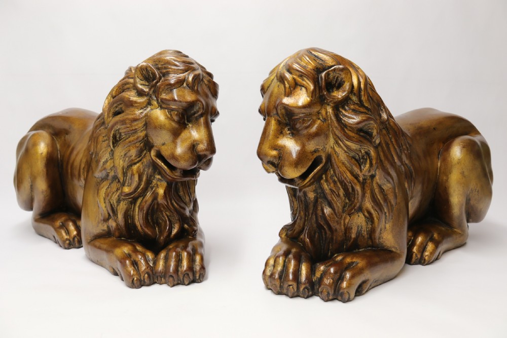 A most impressive 19th century pair of English carved gilt wood classical lions