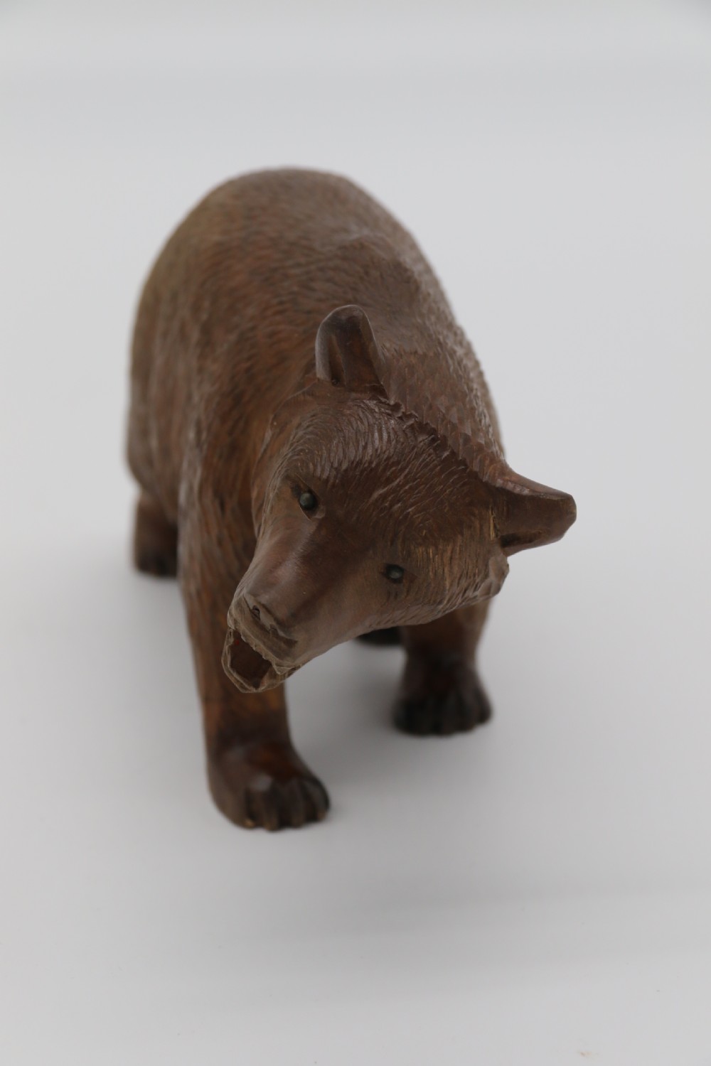 A Swiss Black Forest carved lime wood study of a prowling bear View II
