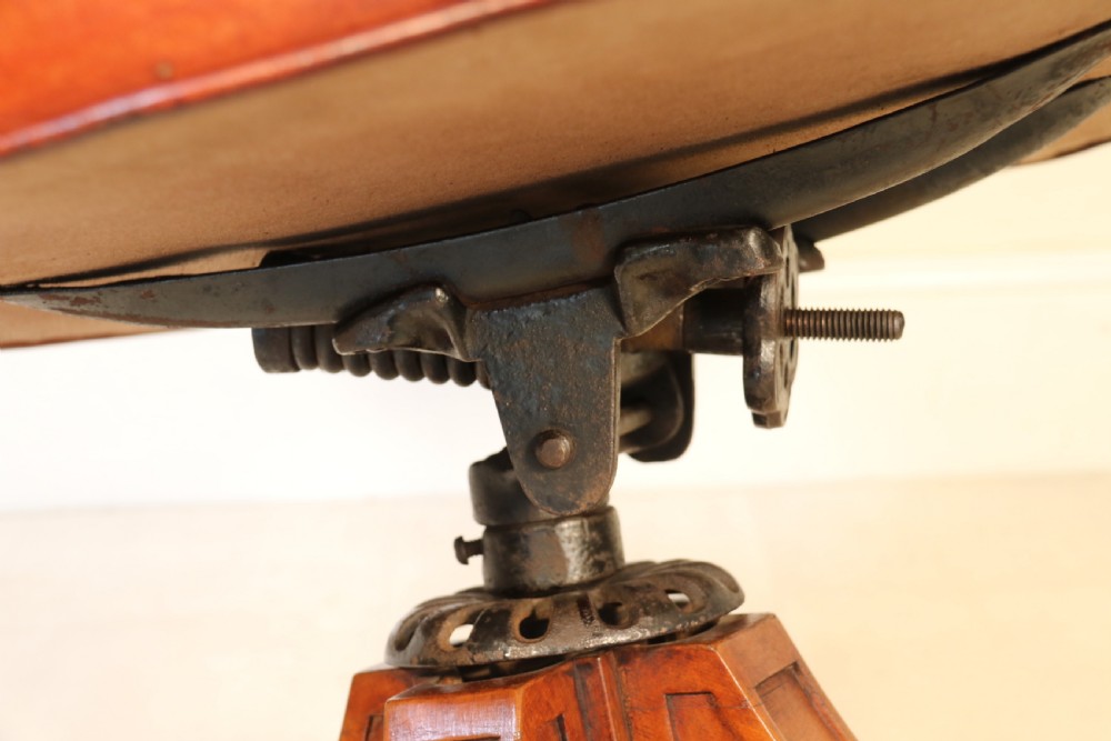 A fully adjustable early 20th C deep buttoned leather upholstered desk chair View XII