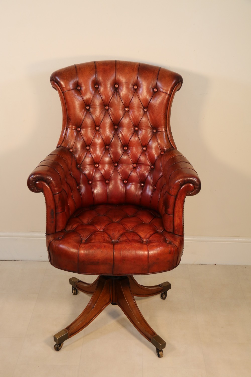 A fully adjustable early 20th C deep buttoned leather upholstered desk chair View XVII