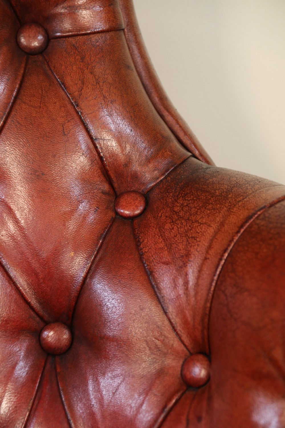 A fully adjustable early 20th C deep buttoned leather upholstered desk chair View XX