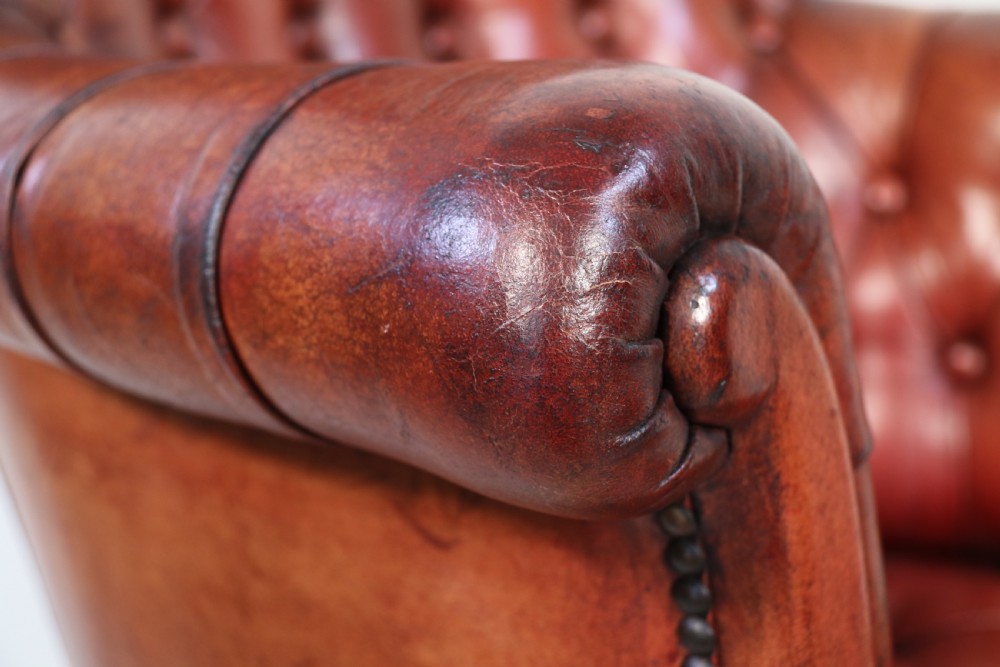A fully adjustable early 20th C deep buttoned leather upholstered desk chair View XXI