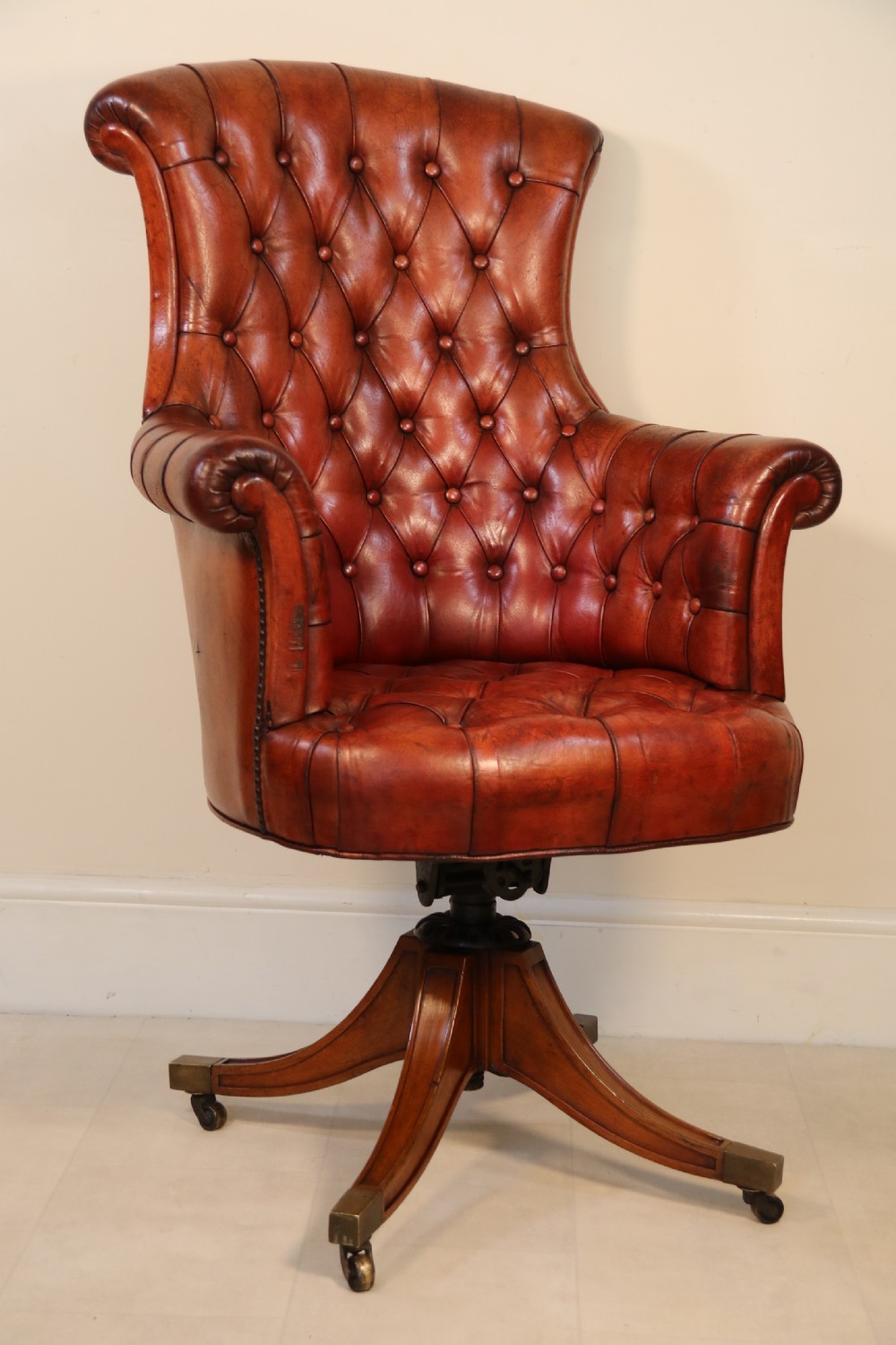 A fully adjustable early 20th C deep buttoned leather upholstered desk chair View XXIV
