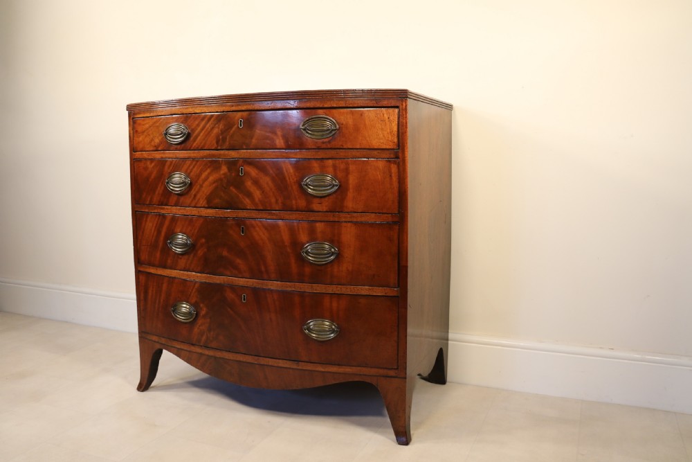 Antique Regency period flame mahogany small bow fronted chest of drawers View II