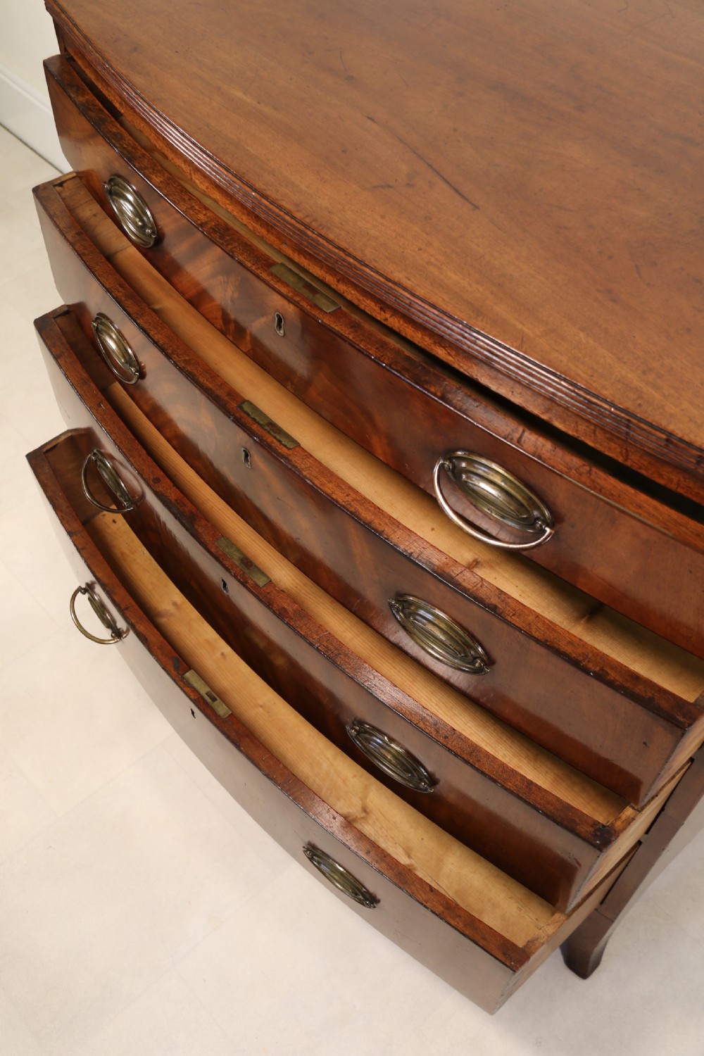Antique Regency period flame mahogany small bow fronted chest of drawers View XIX