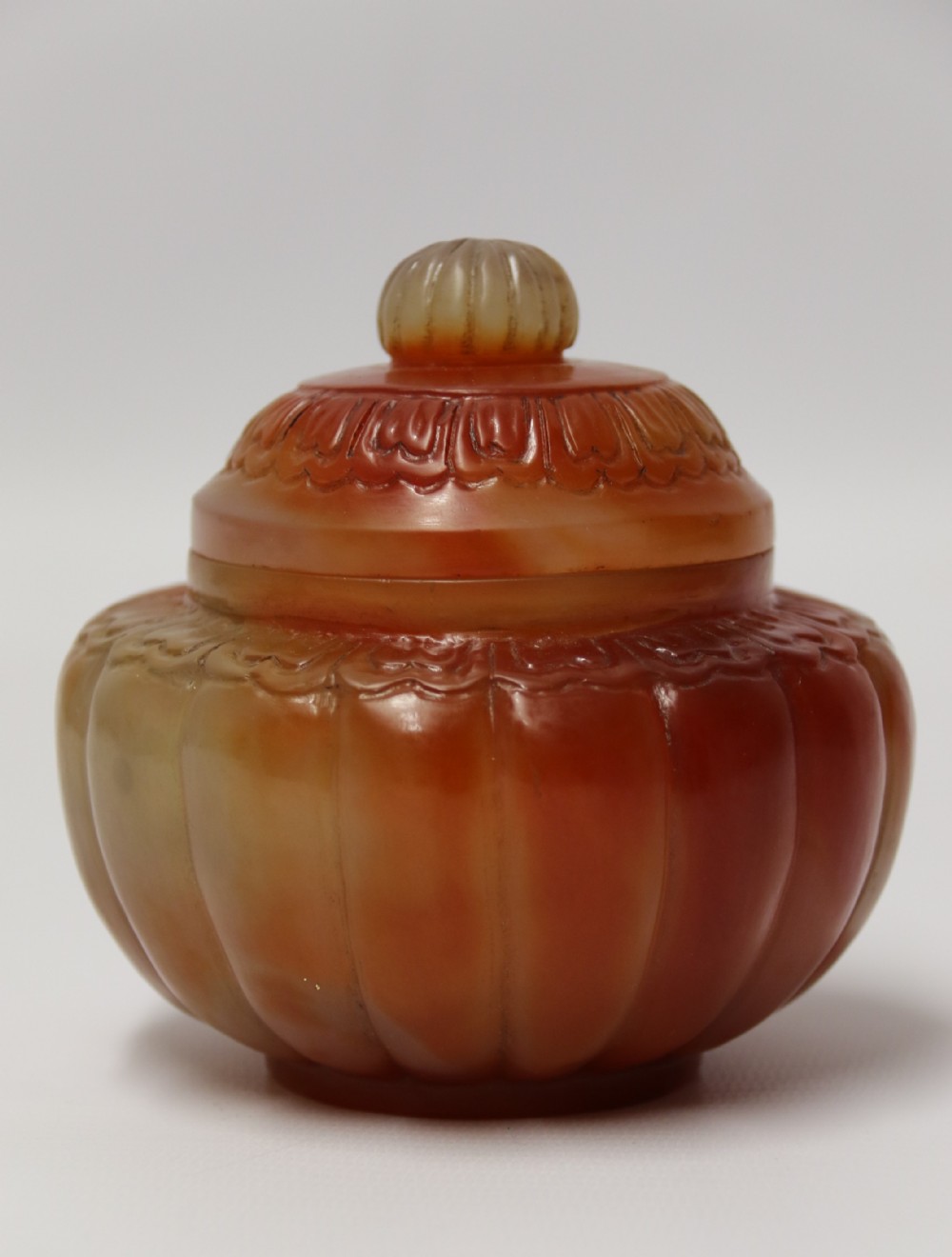 A Chinese hand cut and carved solid agate jar and cover