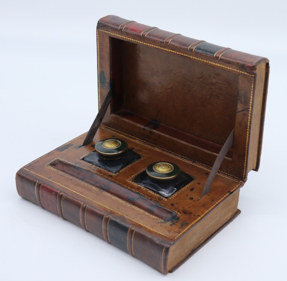 A rare 19th century desk pen and inkstand made in the form of two leather bound books.
