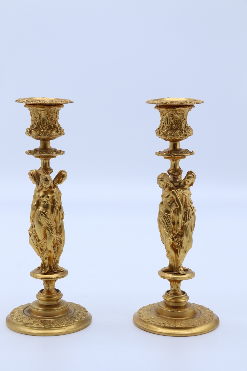 A superb pair of 19th century classical gilt bronze candlesticks.