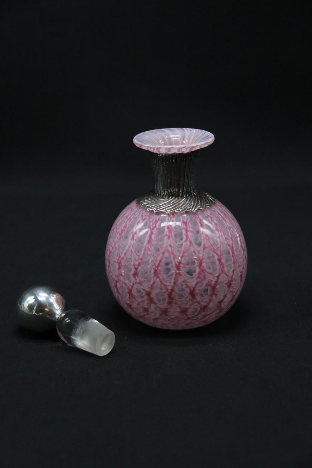 A most unusual 1930s art glass and silver mounted perfume bottle. View II