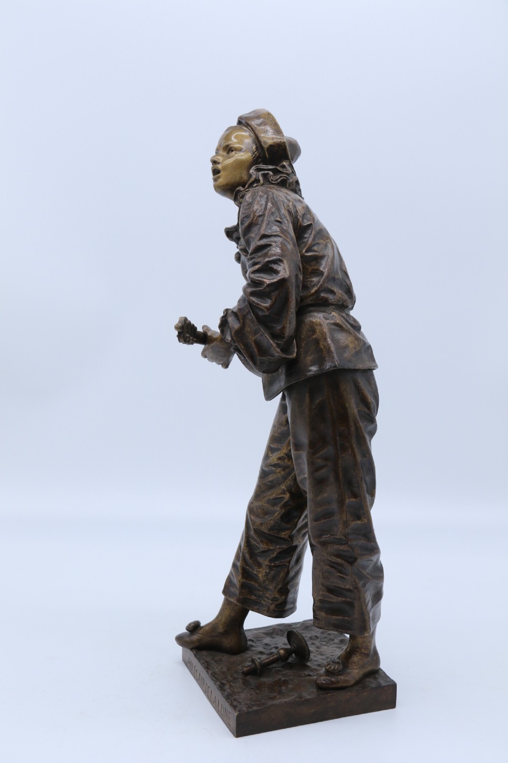 A fine French Bronze sculpture of a Pierrot singing and playing the lute by Bornet.  View VIII