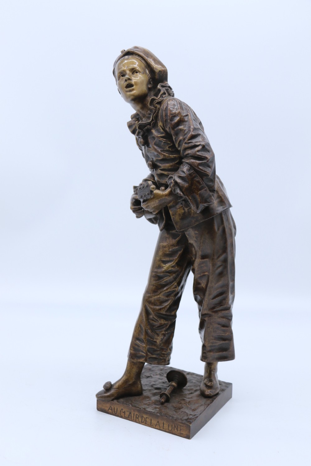 A fine French Bronze sculpture of a Pierrot singing and playing the lute by Bornet.  View IX