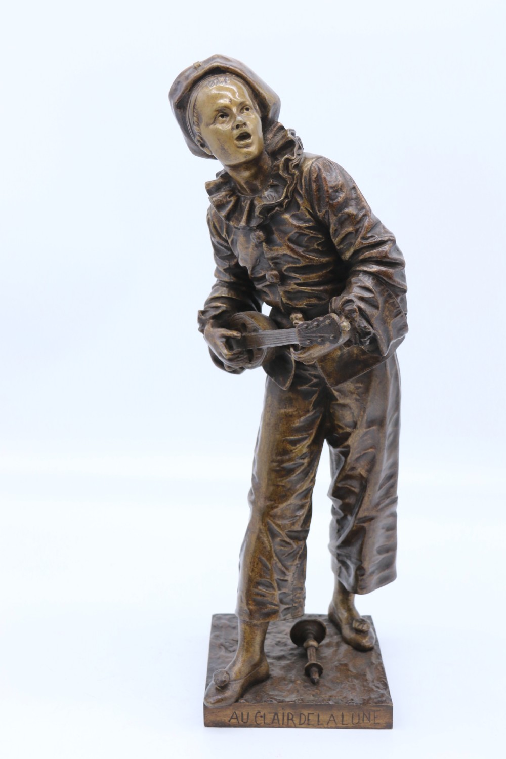 A fine French Bronze sculpture of a Pierrot singing and playing the lute by Bornet.  View X