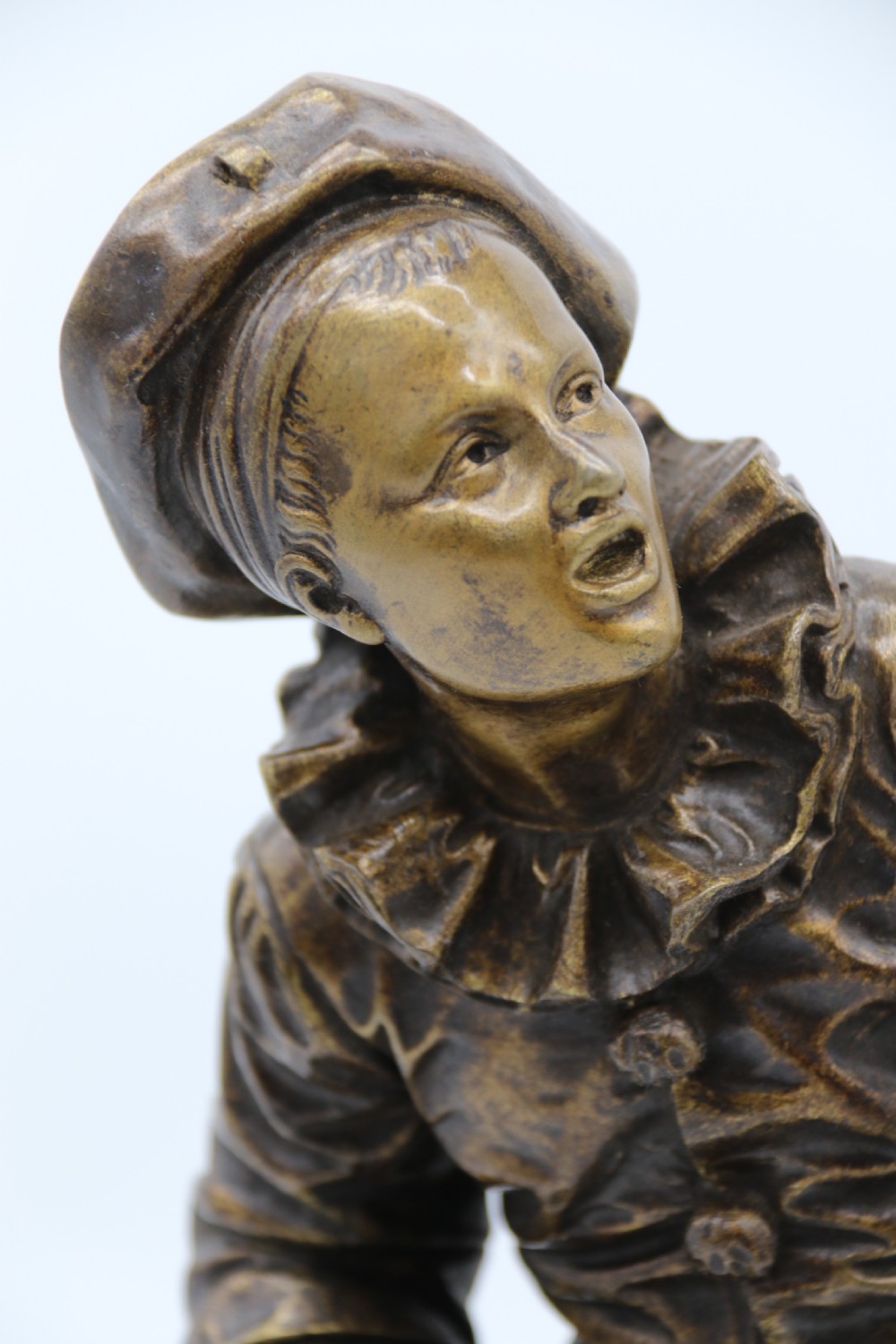 A fine French Bronze sculpture of a Pierrot singing and playing the lute by Bornet.  View XI