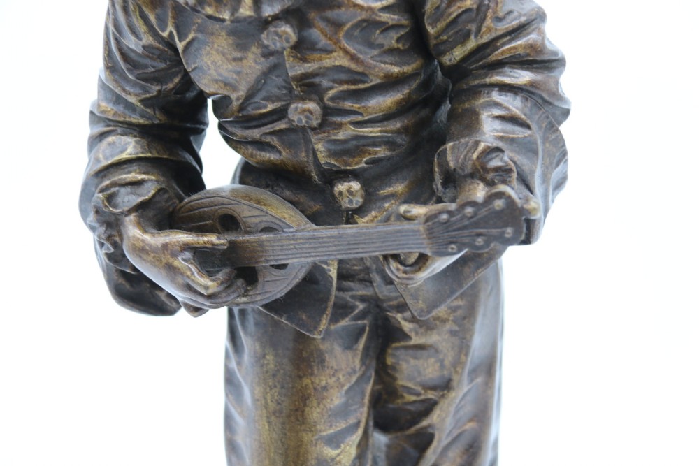 A fine French Bronze sculpture of a Pierrot singing and playing the lute by Bornet.  View XII