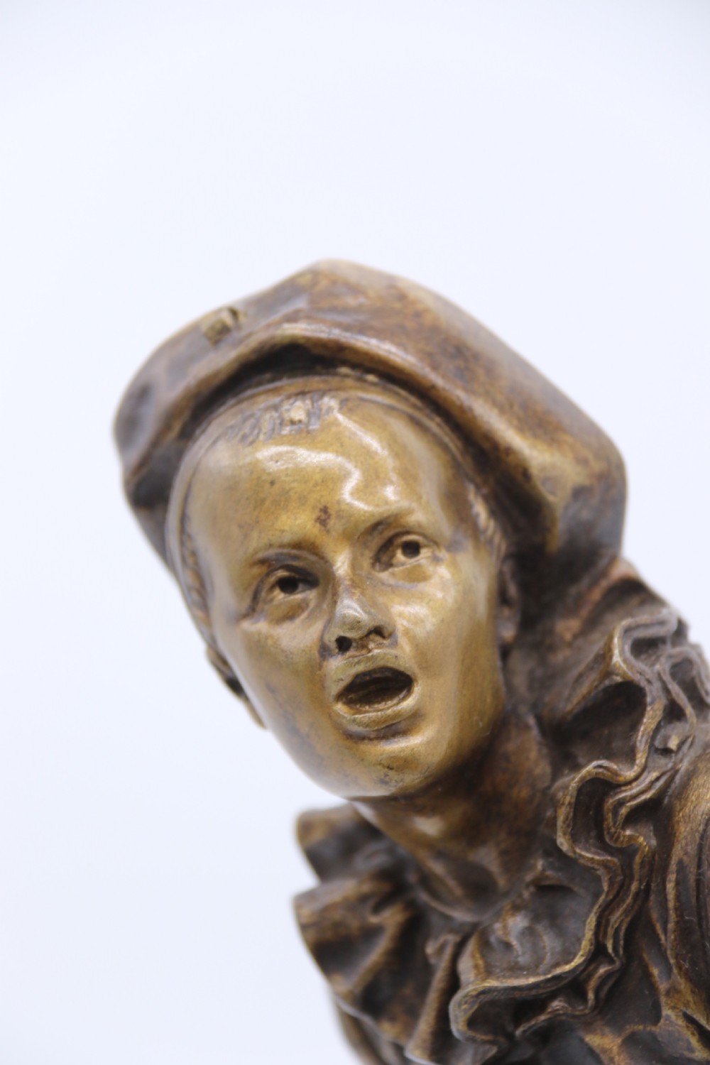 A fine French Bronze sculpture of a Pierrot singing and playing the lute by Bornet.  View XVI