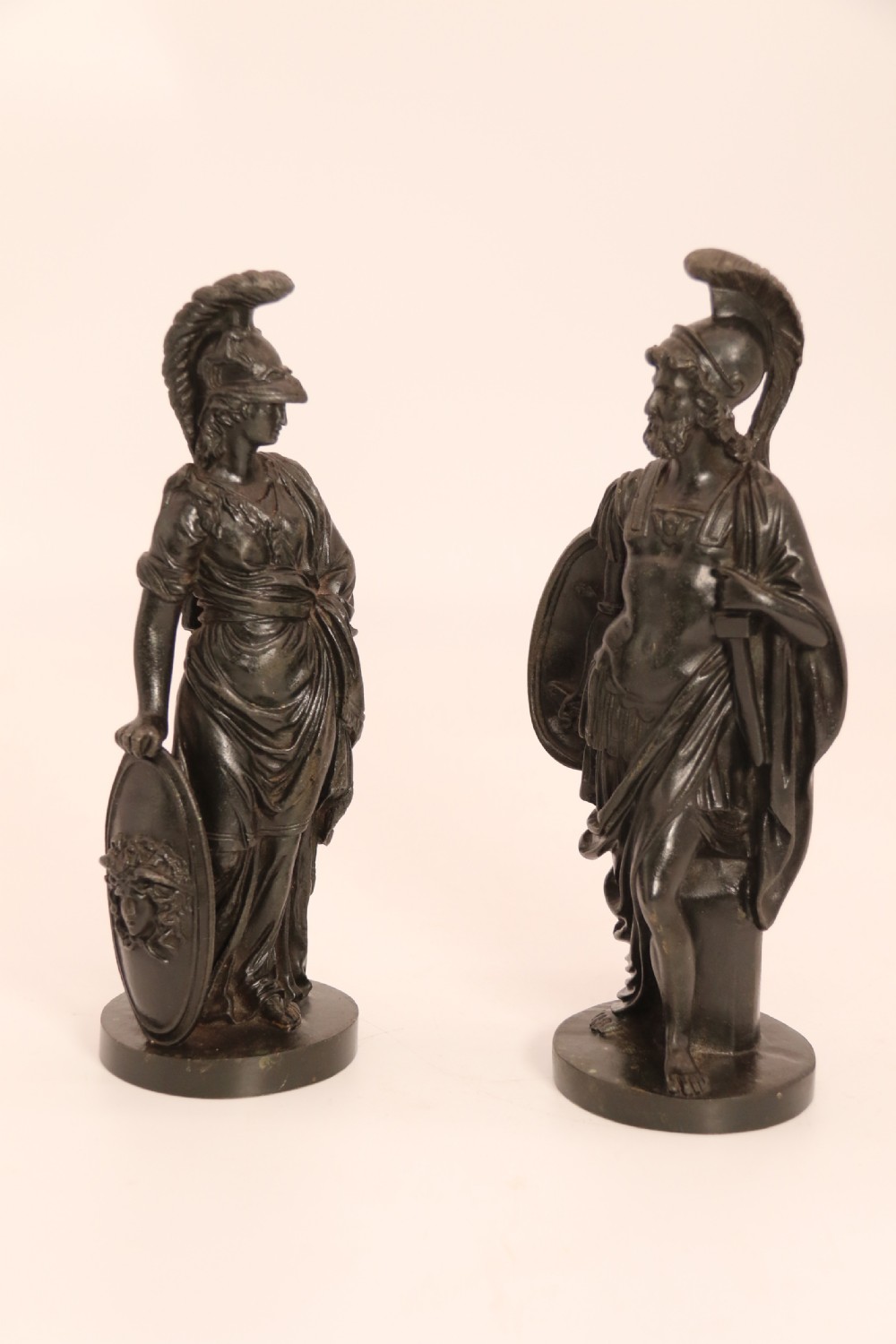 A pair of dark patinated bronze classical figures depicting Athena and Zeus on circular bases. View II