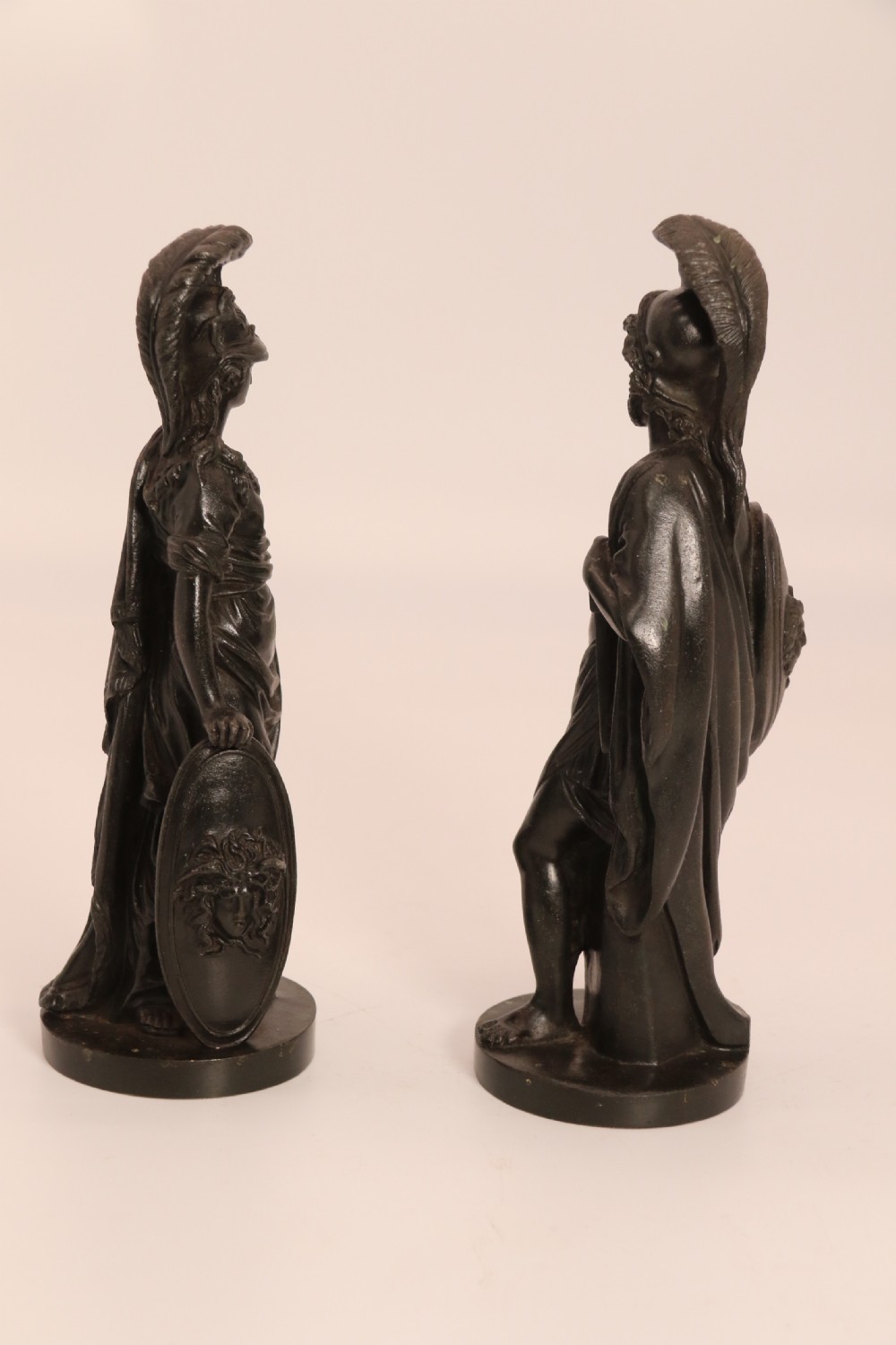 A pair of dark patinated bronze classical figures depicting Athena and Zeus on circular bases. View IV