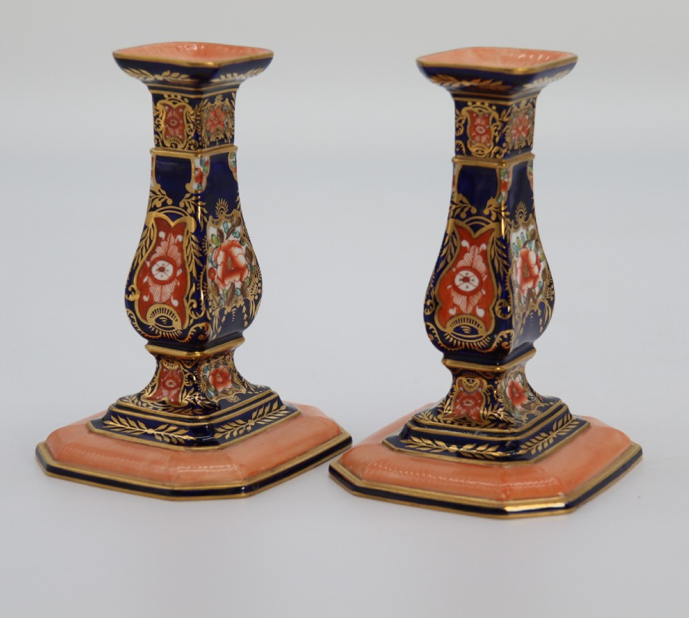 A rare pair of Royal Crown Derby hand painted porcelain candle sticks.

 View III