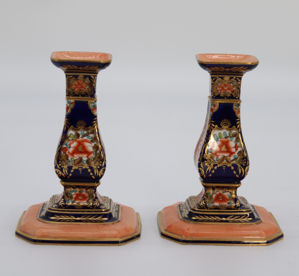 A rare pair of Royal Crown Derby hand painted porcelain candle sticks.

 View IV