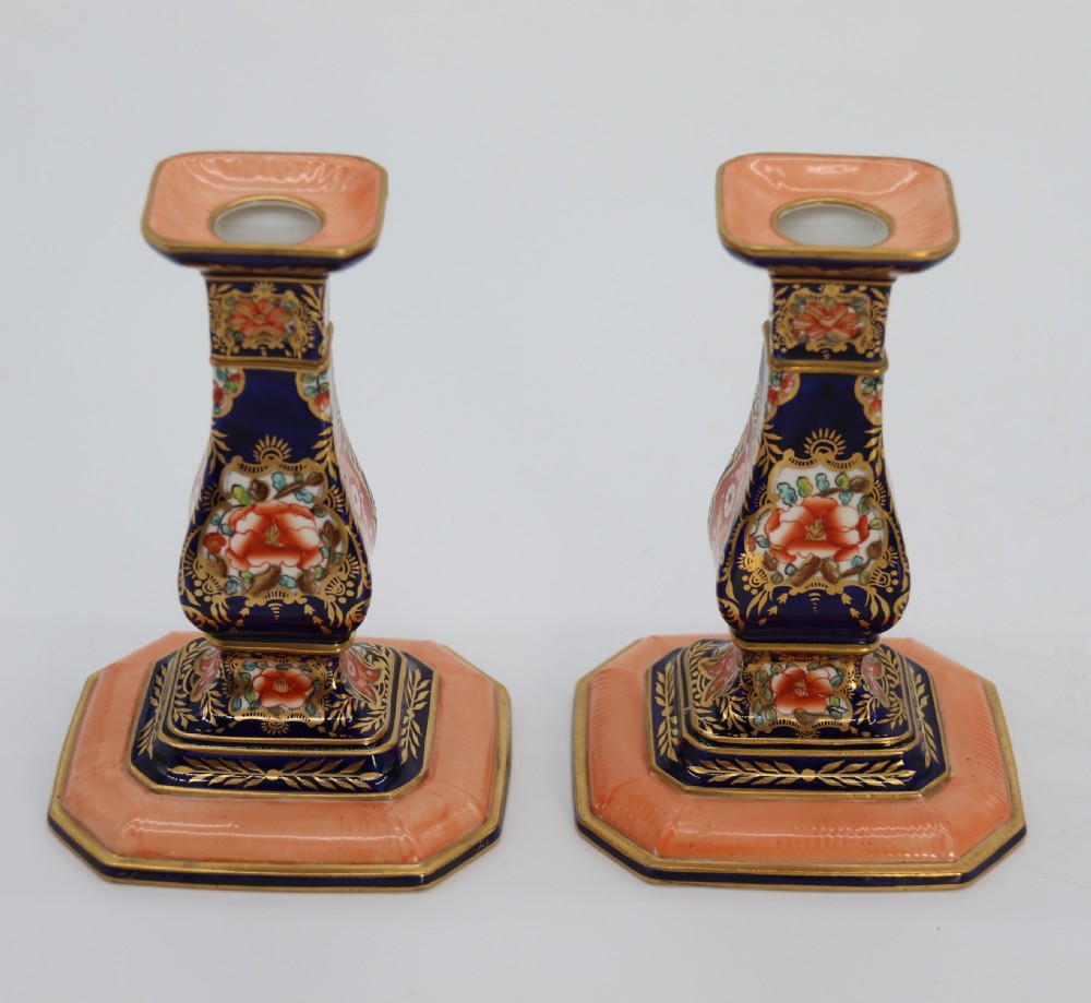 A rare pair of Royal Crown Derby hand painted porcelain candle sticks.

 View V