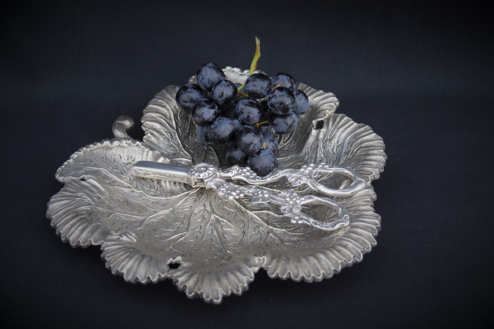 A rare late 19th century silver plated and hand engraved grape salver with matching grape scissors.