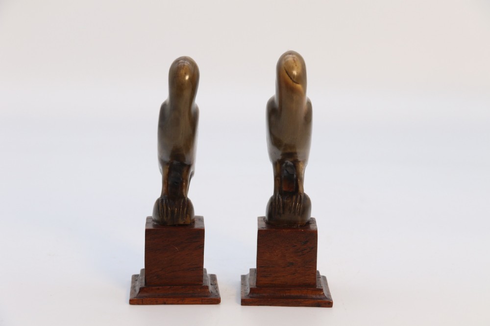 An Indian Raj period pair of carved buffalo horn parrots on wooden stands, circa 1890

 View IV