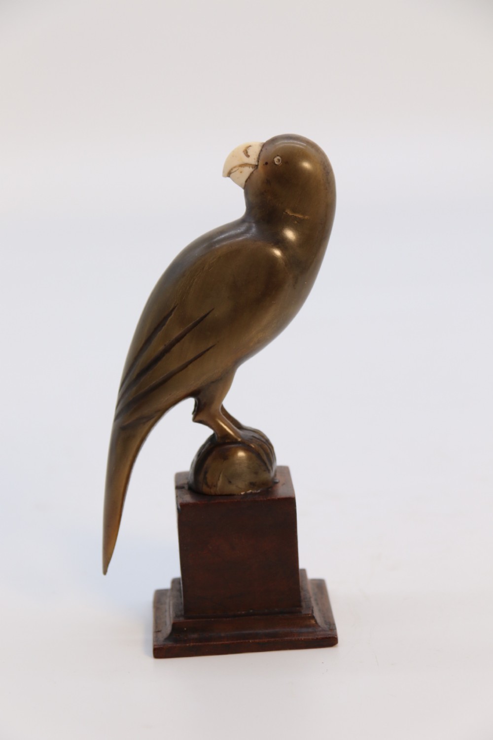 An Indian Raj period pair of carved buffalo horn parrots on wooden stands, circa 1890

 View VII