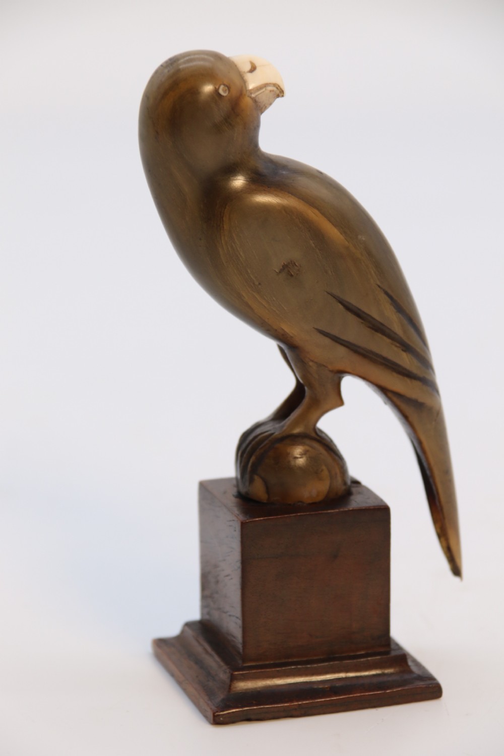An Indian Raj period pair of carved buffalo horn parrots on wooden stands, circa 1890

 View X