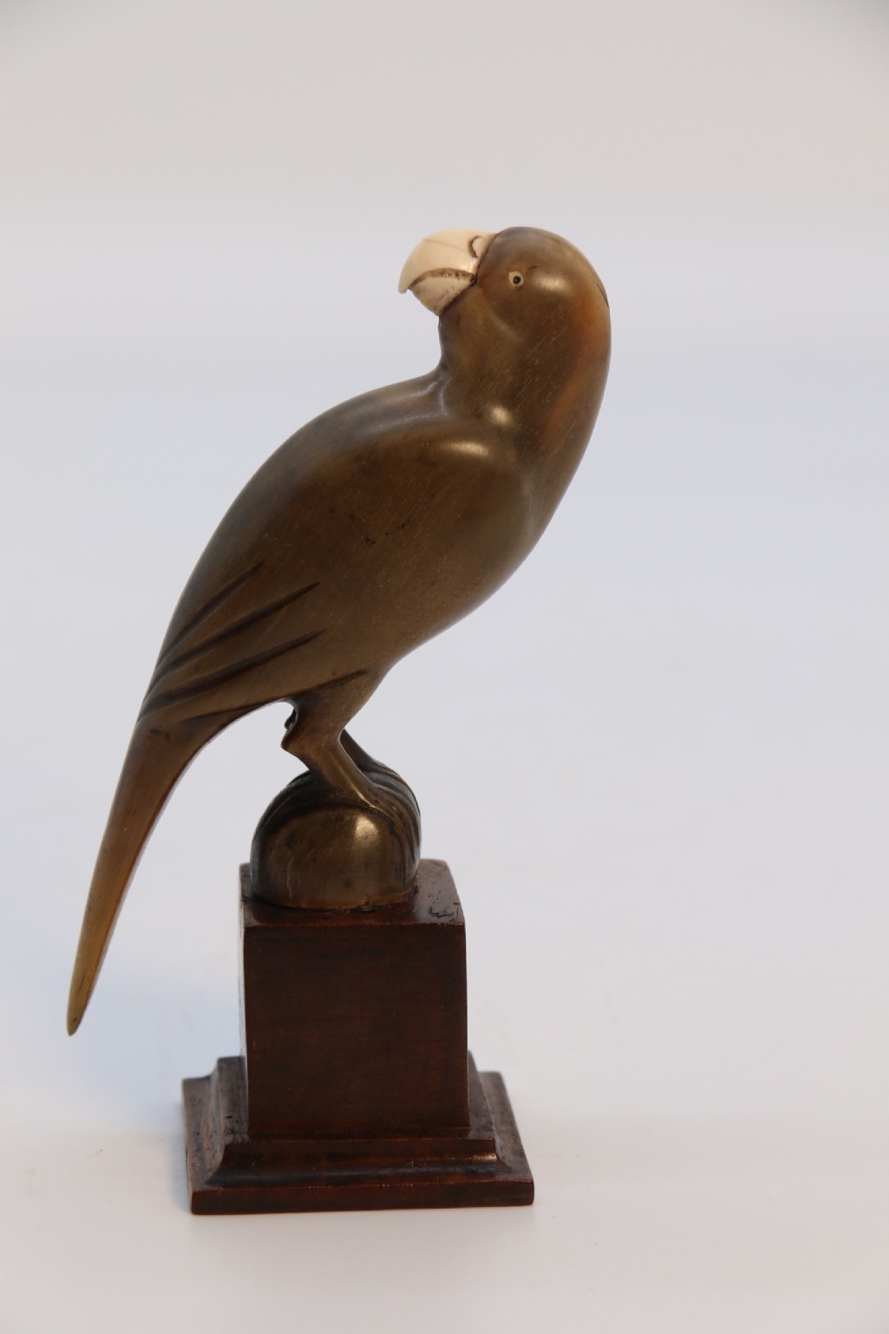 An Indian Raj period pair of carved buffalo horn parrots on wooden stands, circa 1890

 View XVII