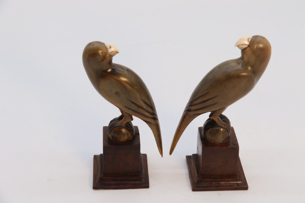 An Indian Raj period pair of carved buffalo horn parrots on wooden stands, circa 1890

 View XXV