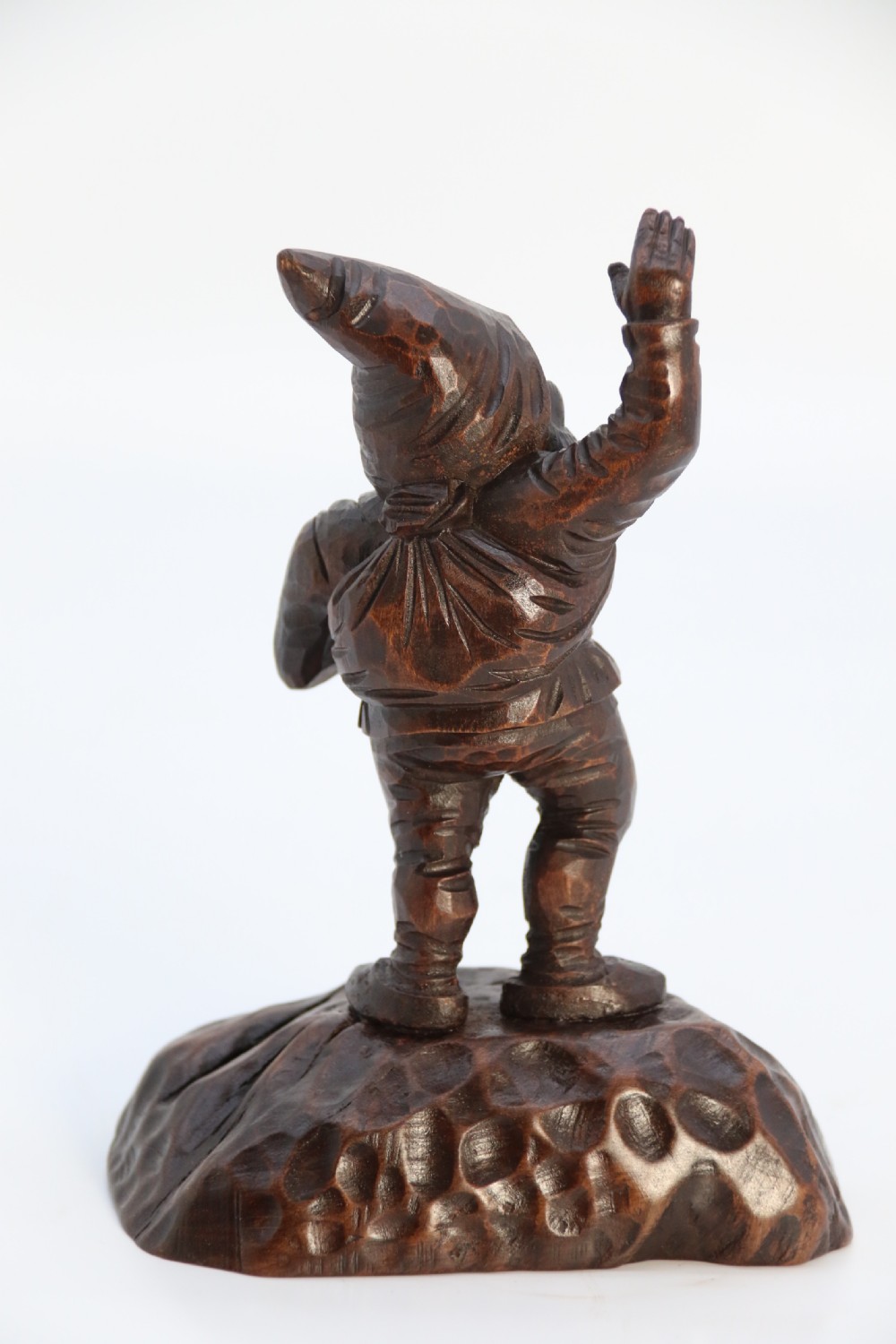 A rare late 19th century Black Forest carved walnut figure of a gnome View V