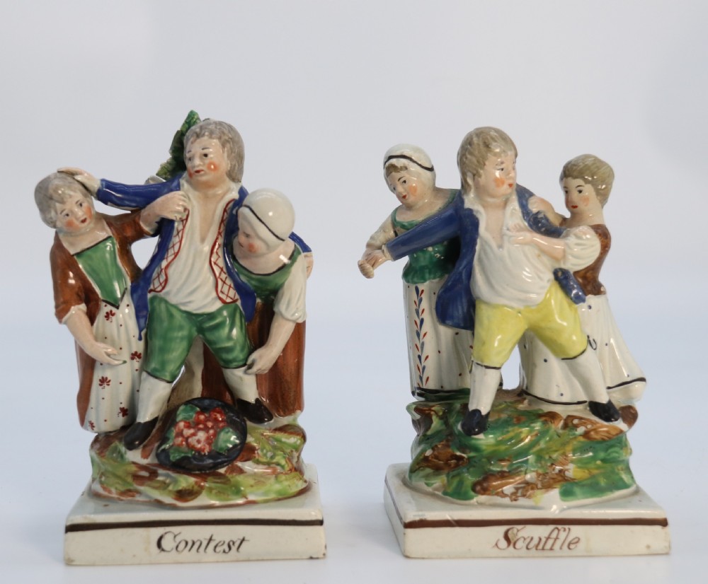 A rare pair of late 18th century English Staffordshire figure groups of two young men about to have a scuffle. View II