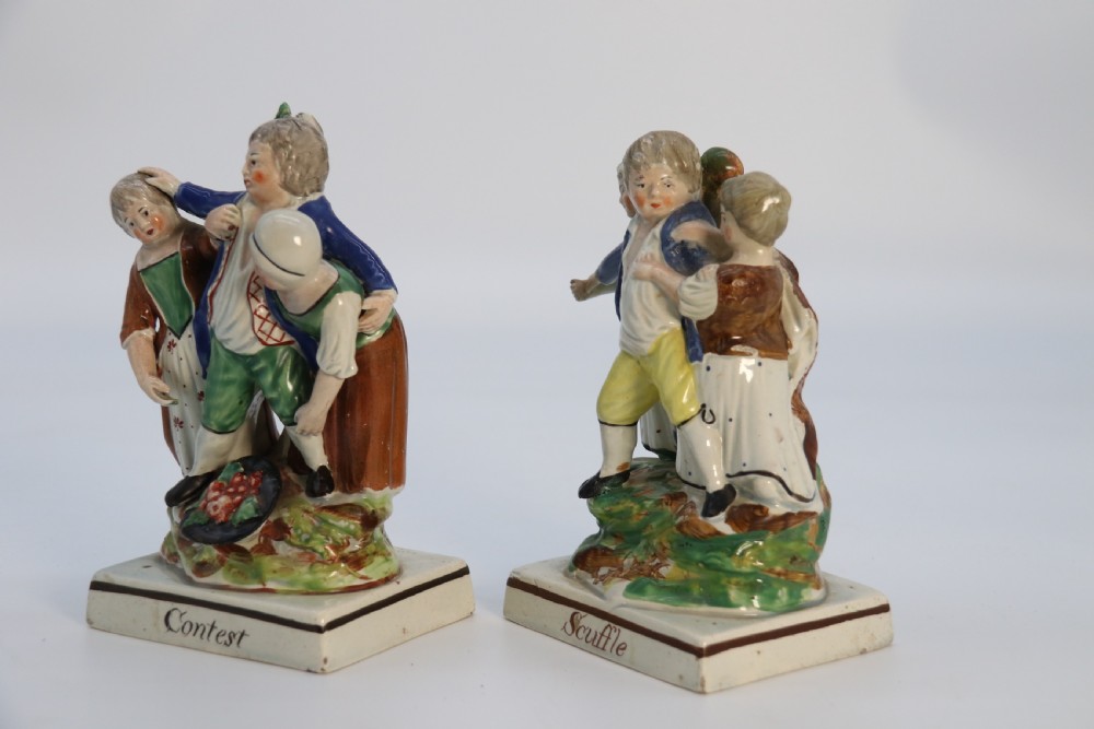 A rare pair of late 18th century English Staffordshire figure groups of two young men about to have a scuffle. View IV