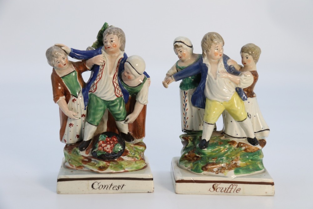 A rare pair of late 18th century English Staffordshire figure groups of two young men about to have a scuffle. View XXV