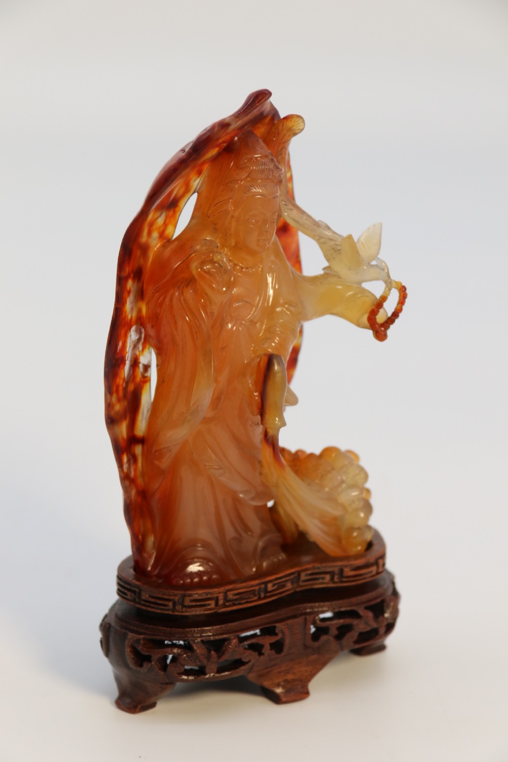 A very fine and rare Chinese hand carved agate hardstone figure of the goddess Guanyin. View II