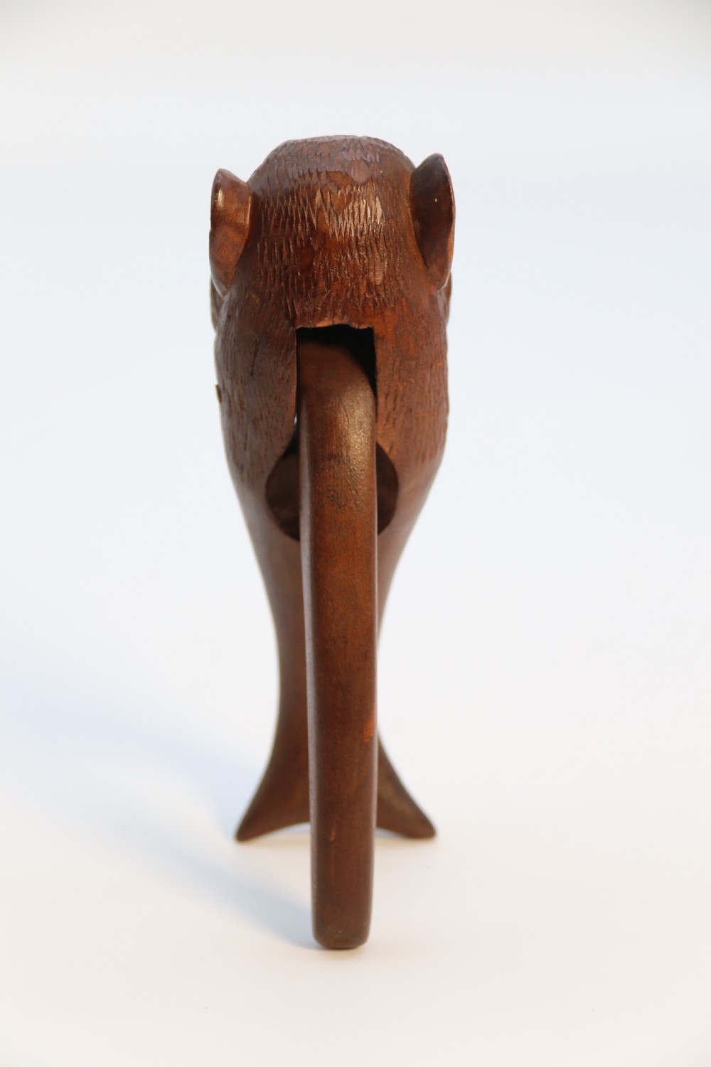 A hand-carved walnut nutcracker shaped as a monkey head with glass bead eyes and a hinged jaw mechanism. View XI