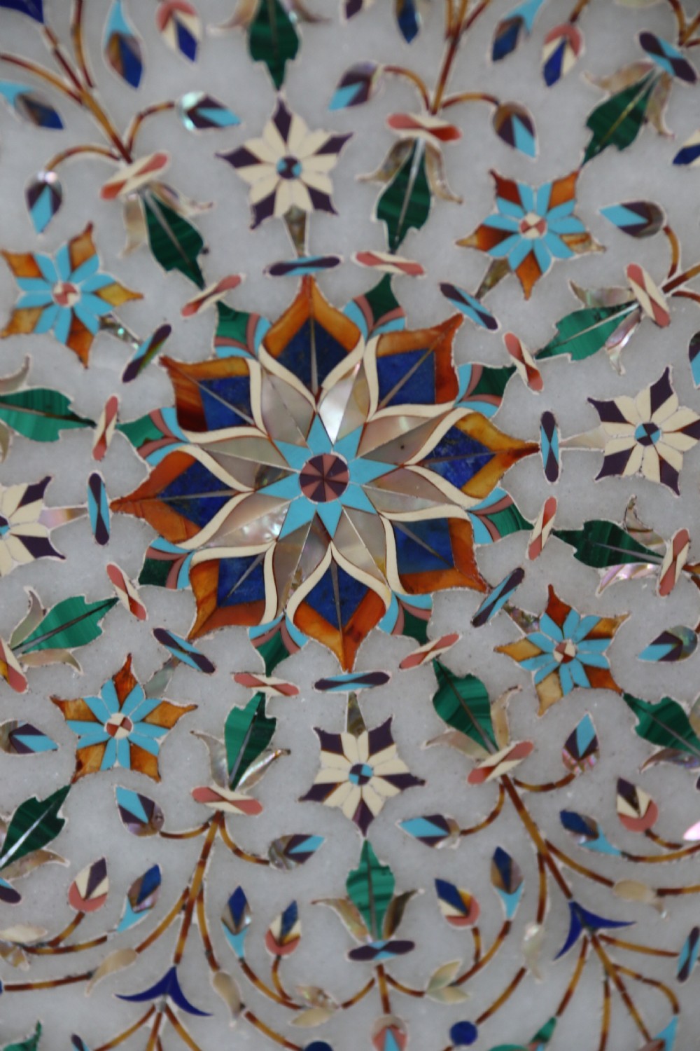 A rare and ultra-fine Raj period Indian white marble charger profusely inlaid with semi-precious cut stones. View II