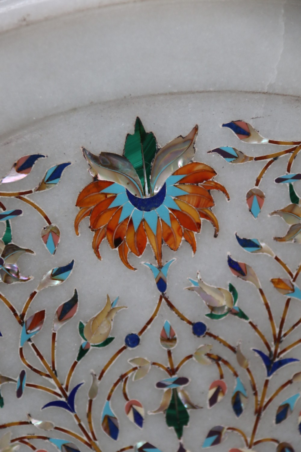 A rare and ultra-fine Raj period Indian white marble charger profusely inlaid with semi-precious cut stones. View III