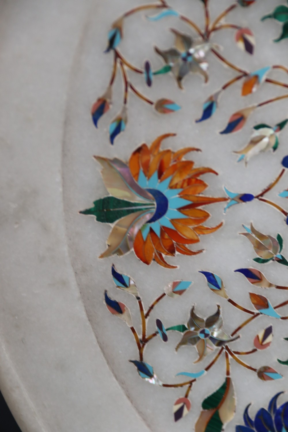 A rare and ultra-fine Raj period Indian white marble charger profusely inlaid with semi-precious cut stones. View IV