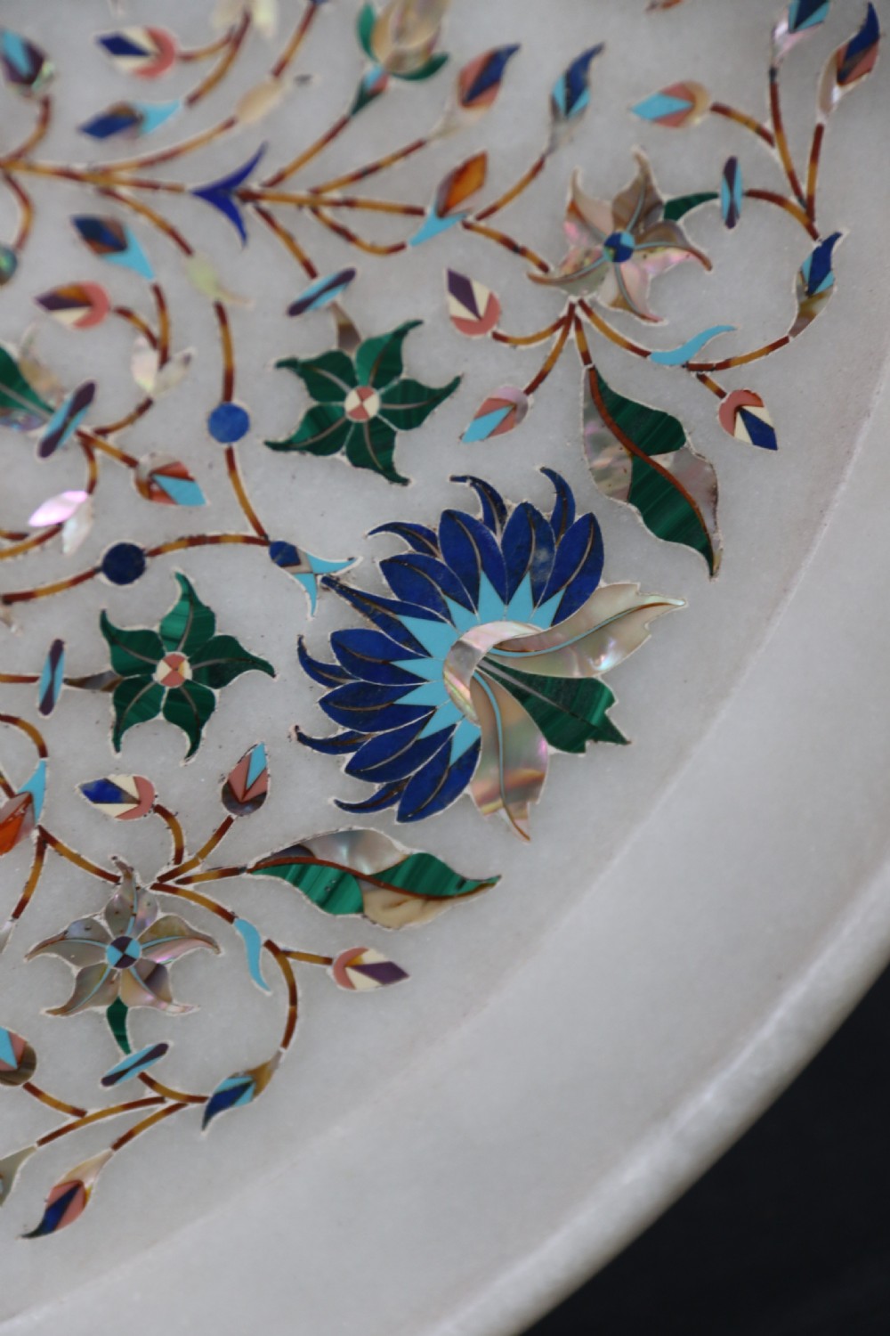 A rare and ultra-fine Raj period Indian white marble charger profusely inlaid with semi-precious cut stones. View V