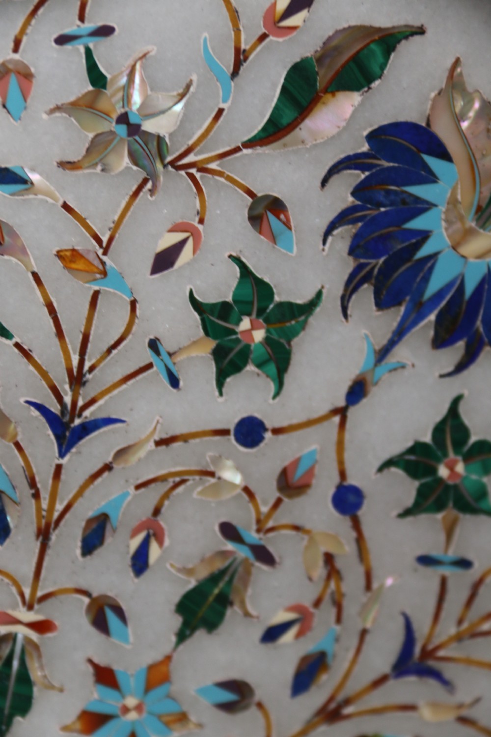 A rare and ultra-fine Raj period Indian white marble charger profusely inlaid with semi-precious cut stones. View VI