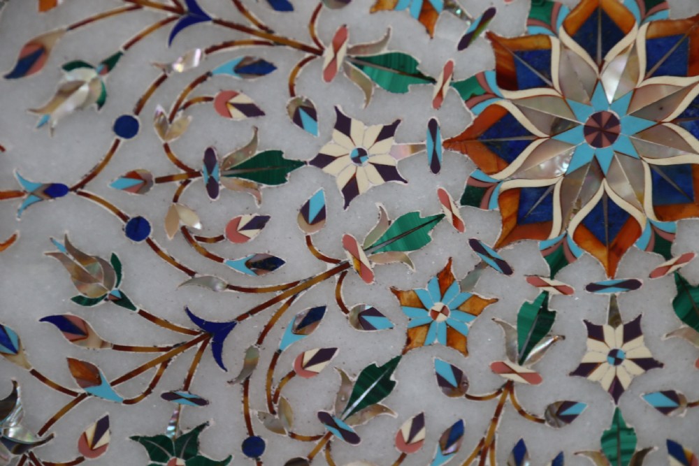 A rare and ultra-fine Raj period Indian white marble charger profusely inlaid with semi-precious cut stones. View VII