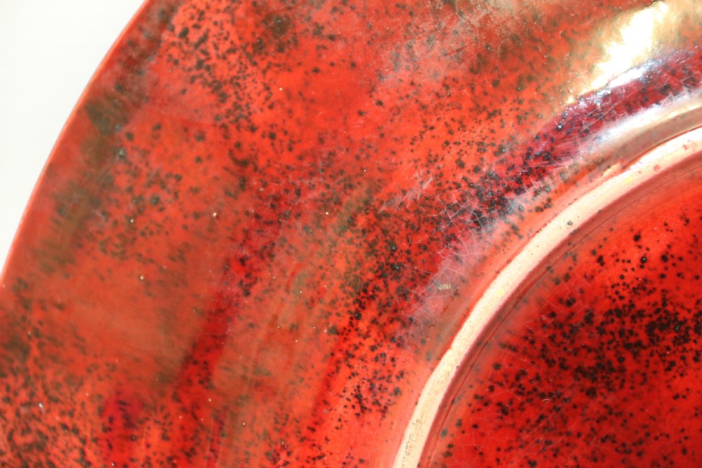 A circular glazed ceramic charger featuring a stylised cream horse motif against a deep red and emerald green reactive glaze. View IX