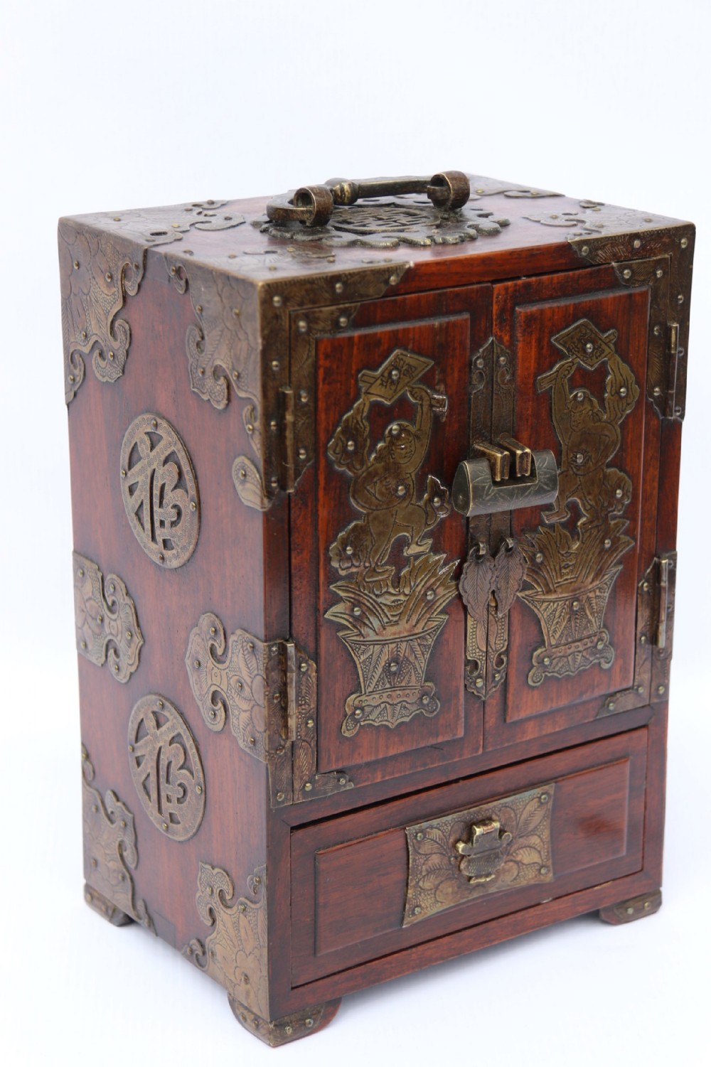 A rare Chinese hardwood and engraved bronze mounted small cabinet with a makers stamp.