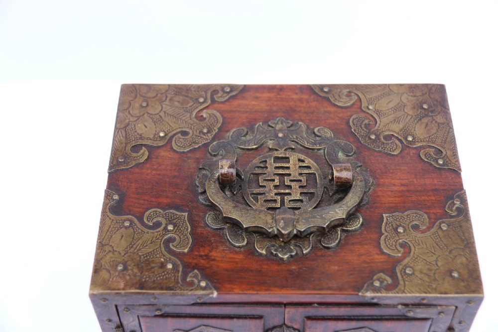 A rare Chinese hardwood and engraved bronze mounted small cabinet with a makers stamp. View XXVI